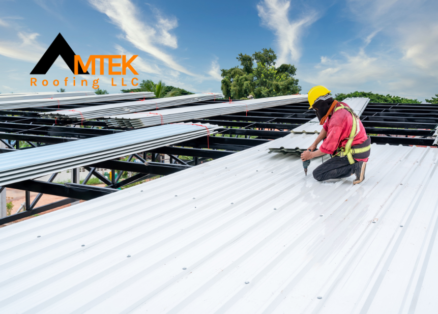 A Roofer Construction worker install new roof, Electric drill used on new roofs with white Metal Sheet. Working at height equipment.